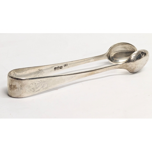 462 - A pair of silver tongs with silver knife. Tongs weigh 27g