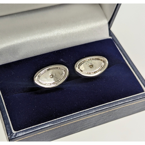 463 - A pair of silver cufflinks.