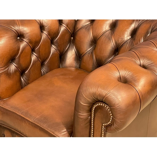 1064 - A deep button leather club armchair. (4)