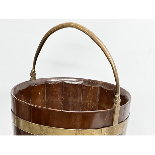 27 - A George III mahogany brass bound peat bucket with brass handle. Circa 1790. 38x37x46cm not includin... 