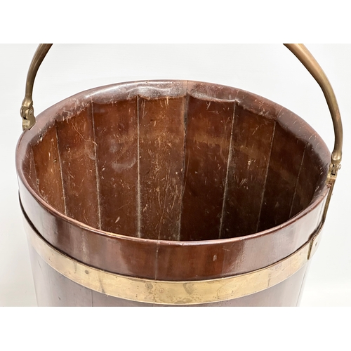 27 - A George III mahogany brass bound peat bucket with brass handle. Circa 1790. 38x37x46cm not includin... 