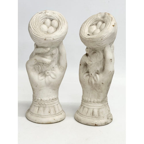 156 - A pair of early 20th century bisque hand garnitures. 19cm