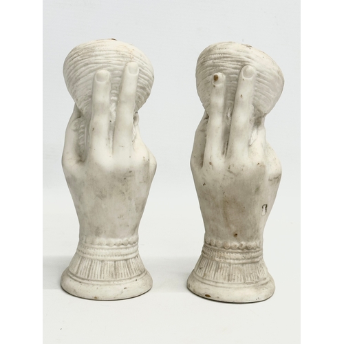 156 - A pair of early 20th century bisque hand garnitures. 19cm