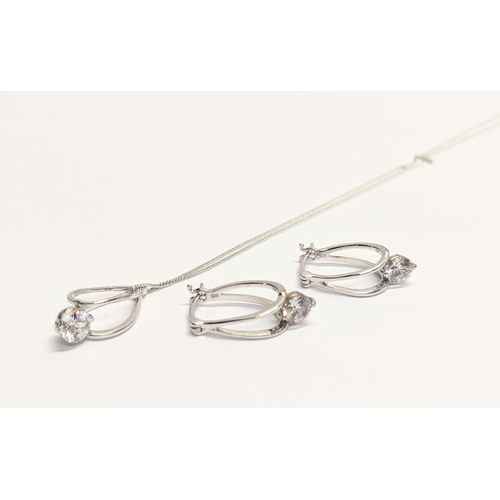 506 - A silver necklace and pendant with a pair of silver earrings.