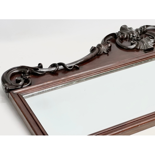 36 - A Victorian carved mahogany framed mirror. 107x46cm