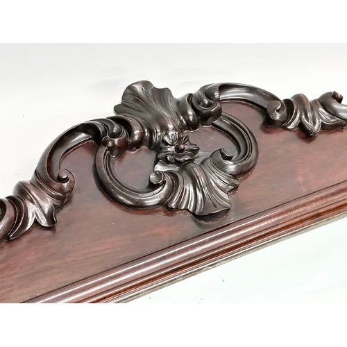 36 - A Victorian carved mahogany framed mirror. 107x46cm