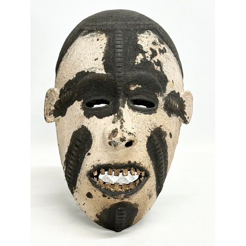 45 - 3 early 20th century African face masks. 28cm