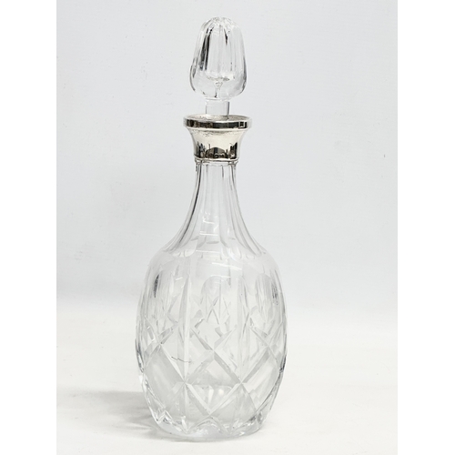 475 - A silver mounted crystal decanter. 30.5cm