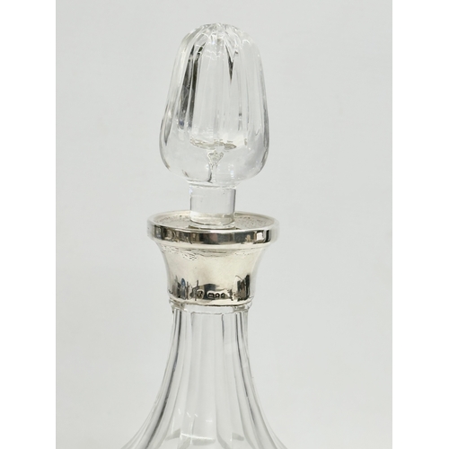 475 - A silver mounted crystal decanter. 30.5cm