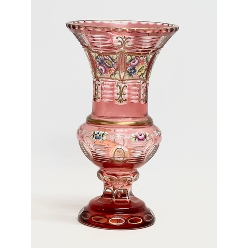 176 - A Bohemian Cranberry Glass Moser style vase with embossed painted flower and gilt decoration. 1950’s... 