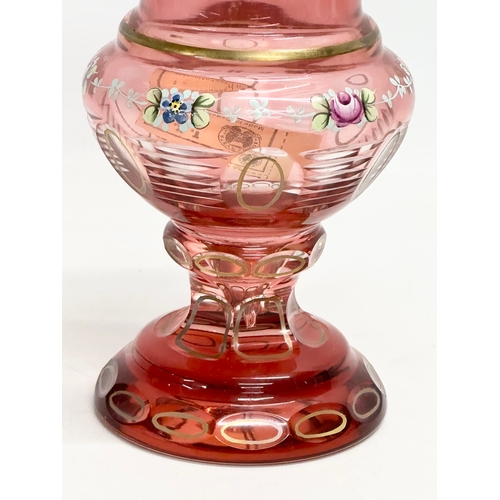 176 - A Bohemian Cranberry Glass Moser style vase with embossed painted flower and gilt decoration. 1950’s... 