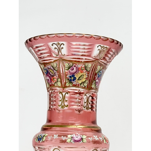 176 - A Bohemian Cranberry Glass Moser style vase with embossed painted flower and gilt decoration. 1950’s... 