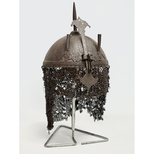 39 - An old reproduction Indo-Persian steel battle helmet on stand.