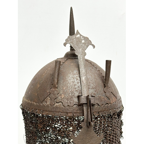 39 - An old reproduction Indo-Persian steel battle helmet on stand.