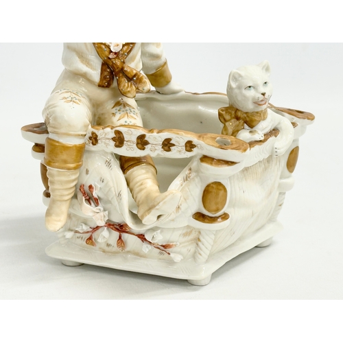 106 - A late 19th century porcelain boy sitting with cat. Makers stamp underneath. 16x12x18cm