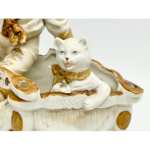 106 - A late 19th century porcelain boy sitting with cat. Makers stamp underneath. 16x12x18cm