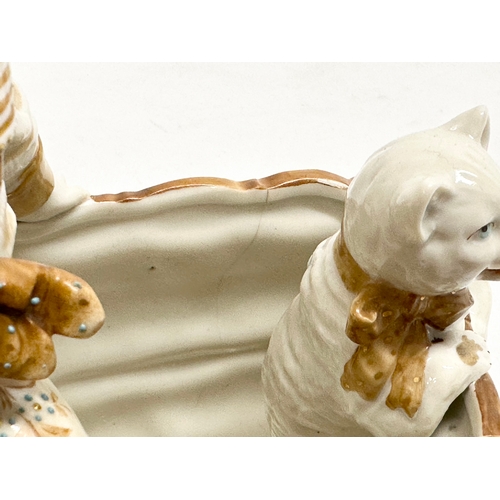 106 - A late 19th century porcelain boy sitting with cat. Makers stamp underneath. 16x12x18cm