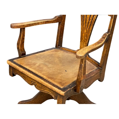 1161 - An early 20th century American oak swivel desk chair. Circa 1900-1910. (7)