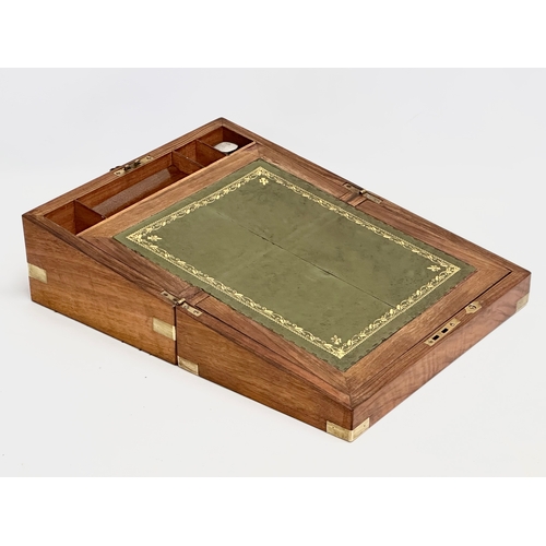 110 - A Victorian walnut brass bound writing slope. Closed 35.5x23x15cm. Open 46.5cm