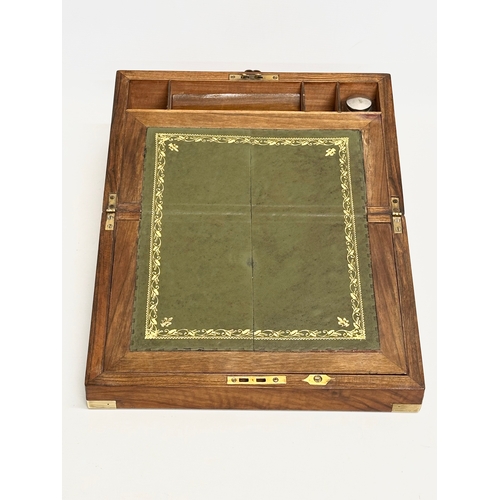 110 - A Victorian walnut brass bound writing slope. Closed 35.5x23x15cm. Open 46.5cm