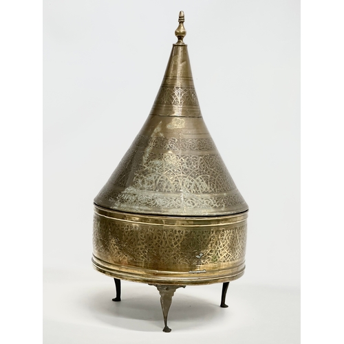 194 - A large early 20th century Moroccan brass Tajine dish with cover. 34x69cm