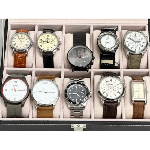 493 - A collection of replica gents watches in display case.