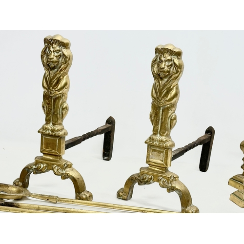 128 - A set of large good quality early 20th century brass fire andirons and tools. 24x41x44cm