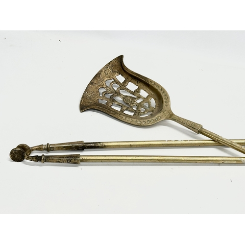 128 - A set of large good quality early 20th century brass fire andirons and tools. 24x41x44cm