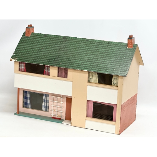 619 - A vintage dolls house. 62x27x50cm