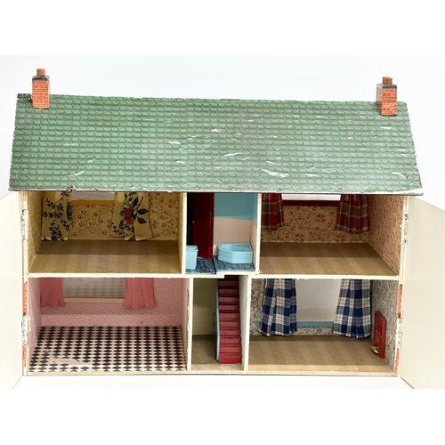 619 - A vintage dolls house. 62x27x50cm