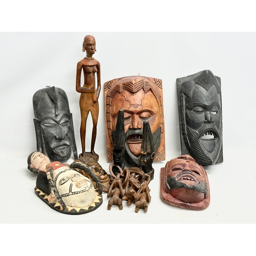 279G - A quantity of vintage African figures and masks. Largest mask 42.5cm. Largest figure 60cm