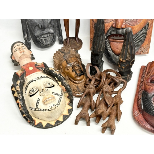 279G - A quantity of vintage African figures and masks. Largest mask 42.5cm. Largest figure 60cm