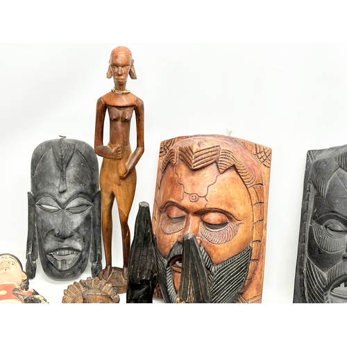 279G - A quantity of vintage African figures and masks. Largest mask 42.5cm. Largest figure 60cm