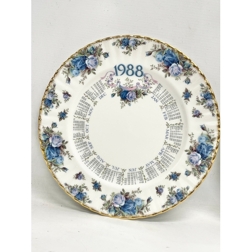 299R - A Royal Albert ‘Moonlight Rose’ wall clock and 2 matching calendar plates. 26.5cm