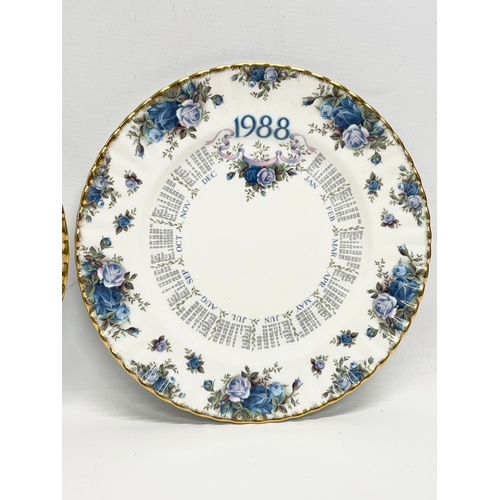 299R - A Royal Albert ‘Moonlight Rose’ wall clock and 2 matching calendar plates. 26.5cm