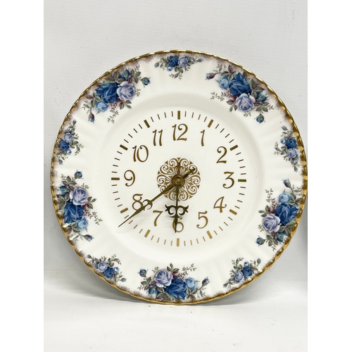 299R - A Royal Albert ‘Moonlight Rose’ wall clock and 2 matching calendar plates. 26.5cm