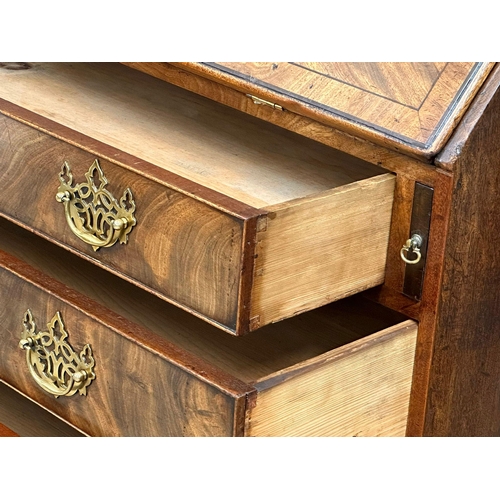 1012 - A George III mahogany writing bureau with original brass drop handles and 3 drawers on bracket feet.... 