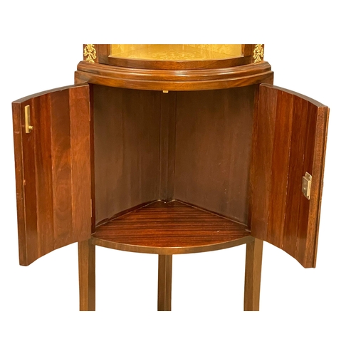 1015 - A mahogany bow front corner cabinet with brass ormolu mounts on splayed feet. 52x34x171.5cm (3)