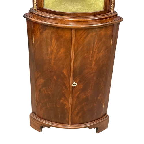 1016 - A mahogany bow front corner cabinet with brass ormolu mounts. 55x37x169.5cm (3)