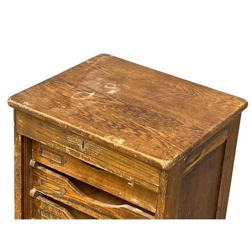 1041 - An Edwardian oak tambour door filing cabinet. 45x40x120cm (8)