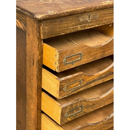 1041 - An Edwardian oak tambour door filing cabinet. 45x40x120cm (8)