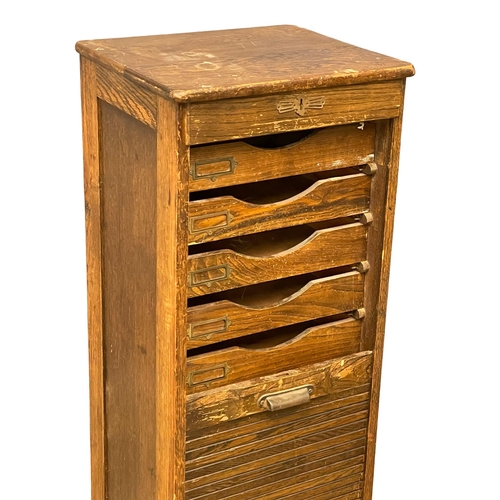 1041 - An Edwardian oak tambour door filing cabinet. 45x40x120cm (8)