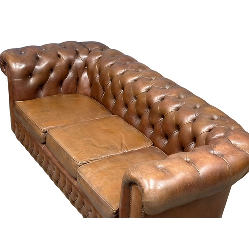 1065 - A vintage deep button leather 3 seater sofa. 191cm (4)