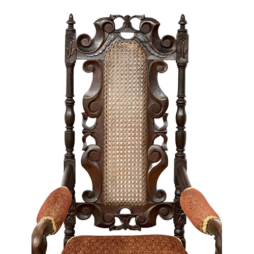 1069 - A large early 20th century Jacobean style oak armchair. Circa 1900-1920. (4)