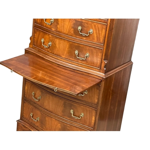 1076 - A vintage George III style mahogany serpentine front tallboy chest of drawers with brushing slide an... 