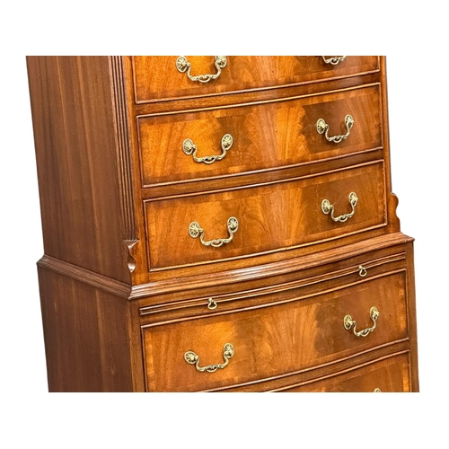 1076 - A vintage George III style mahogany serpentine front tallboy chest of drawers with brushing slide an... 