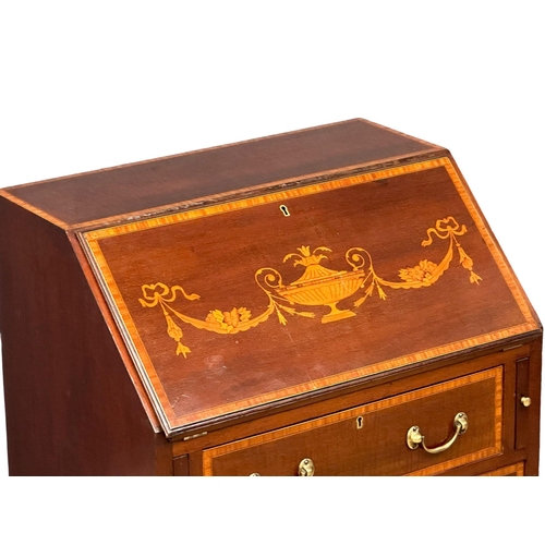 1079 - An early 20th century Sheraton Revival inlaid mahogany writing bureau. 61x42x93cm (4)