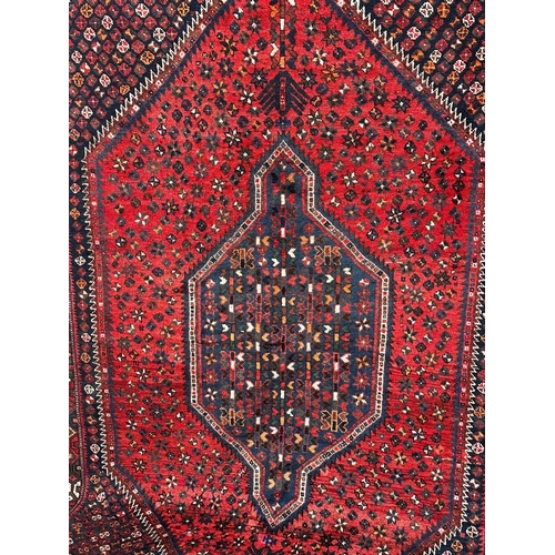 1089 - A large vintage Iranian hand knotted wool pile rug. 159x267cm