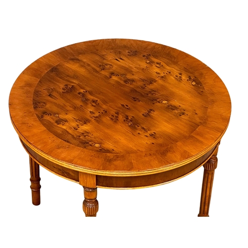 1097 - A Yew Wood coffee table on reeded legs. 61x48.5cm (8)