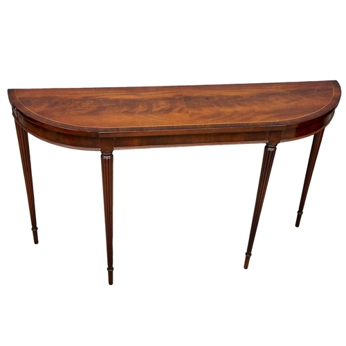 1104 - A Regency style inlaid mahogany console table with rosewood crossbanding on reeded legs. 123x30x72cm... 